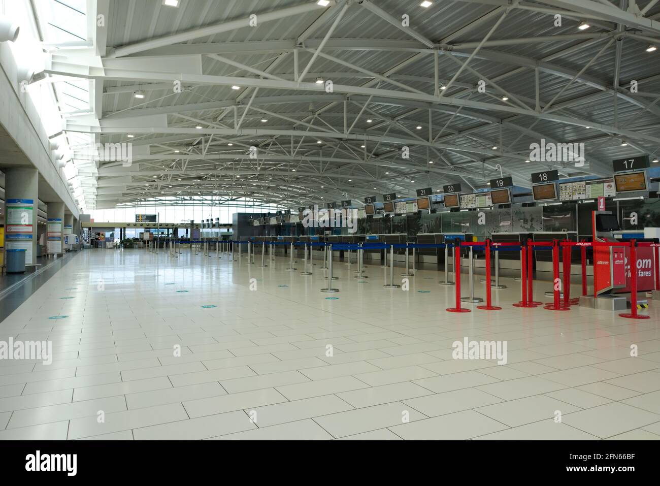 Larnaca – Cyprus – May 12, 2021: Empty check-in counters in empty departure terminal at Larnaca Airport Stock Photo