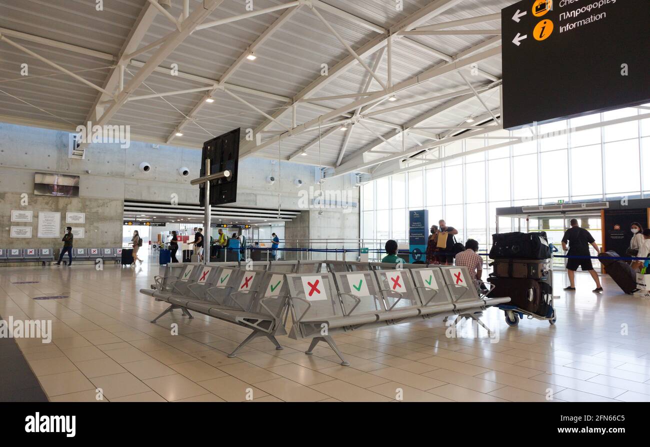Larnaca – Cyprus – May 12, 2021: Airport seats marked for social distancing Stock Photo