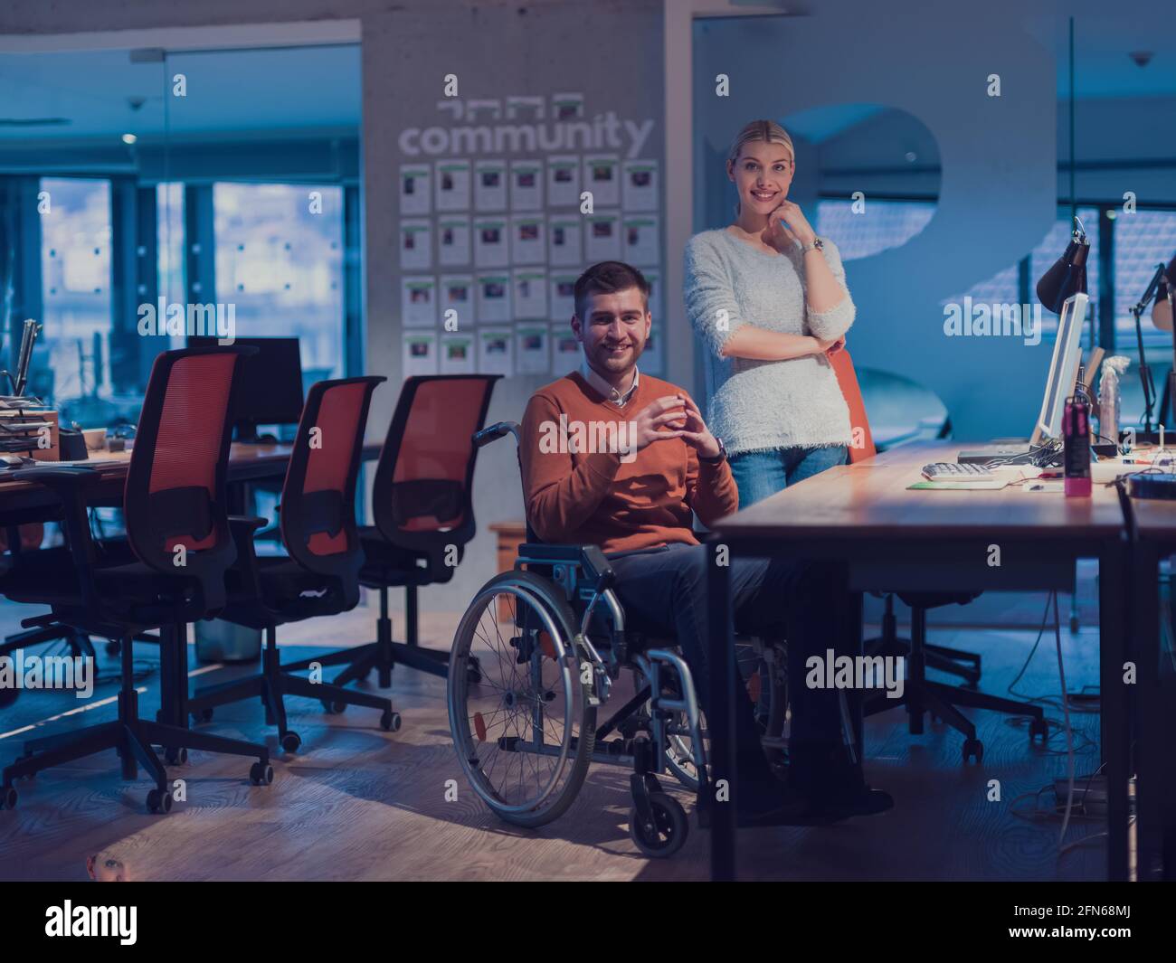 Businessman in a wheelchair in modern coworking office space working ...