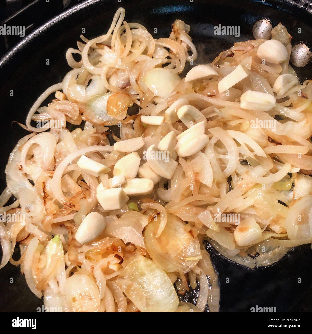 Sauteed Onions and Garlic in Frying Pan Stock Photo