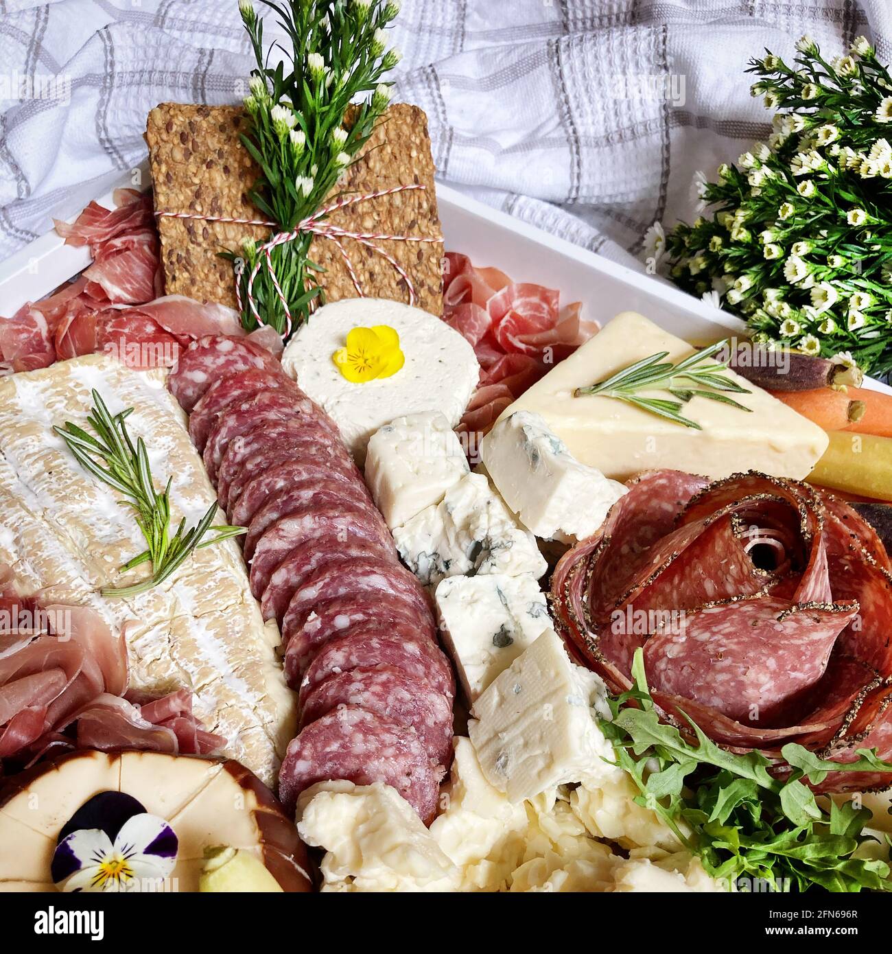 Charcuterie Grazing Board with Sausage, Salami, Cheese and Beet Hummus Stock Photo