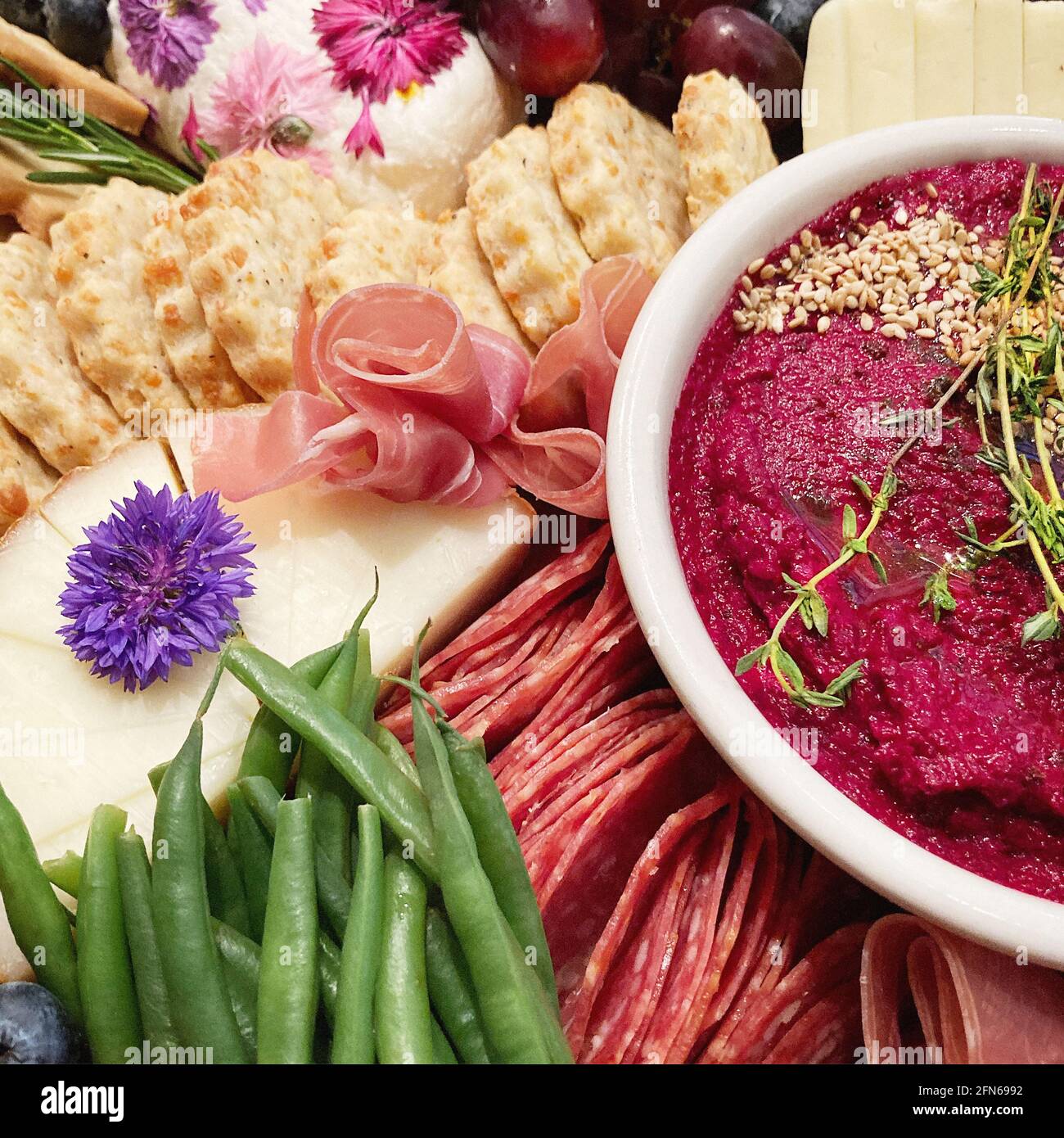 Grazing Board with Vegetables, Meat Cheese and Beet Hummus Stock Photo