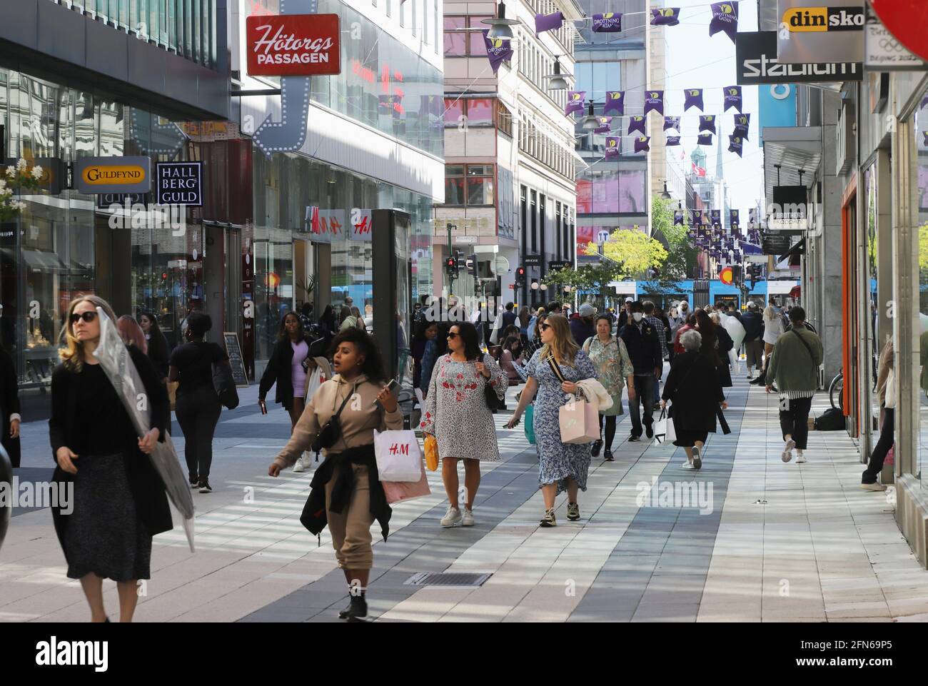 Stockholm, Sweden - May 12, 2021: People walking the crowded pedestrian only Drottninggatan street a shopping area in the downtown district. Stock Photo