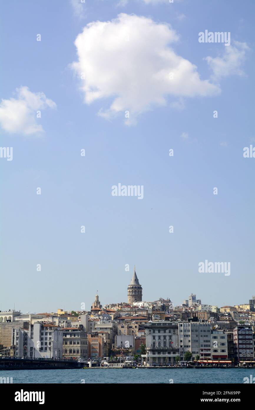 Wide angled view of Istanbul and the Galata bridge and tower with an open blue sky and a few white clouds. Stock Photo