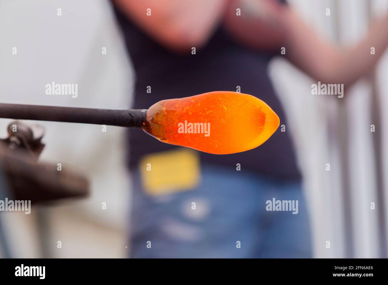 A glass blower's pipe with a gob (or blob) of molten glass on the end