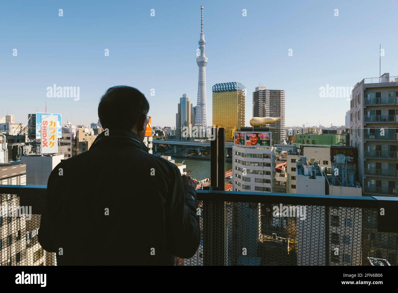 Tokyo, Japan - January 10, 2016: Japanese tourist enjoying the view from the top floor of the Asakusa Culture Tourist Information Center. Stock Photo