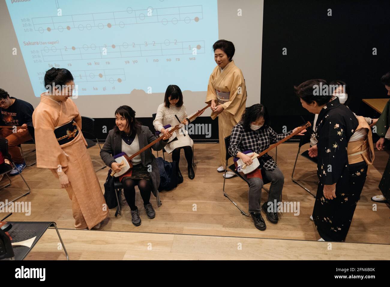 Tokyo, Japan - January 10, 2016: Japanese artists teaching tourists to play the Shamisen traditional japanese instrument at the Asakusa Culture Touris Stock Photo