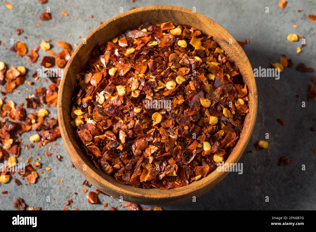 Raw Organic Red Pepper Flakes in a Bowl Stock Photo