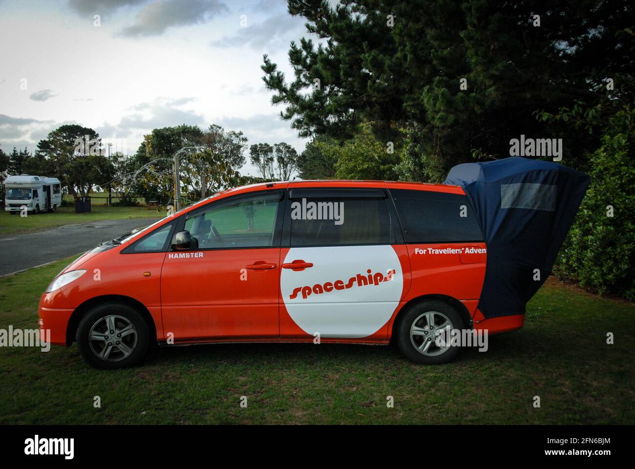 In the land of the camper vans: a small camper van for two people with tent  extension Stock Photo - Alamy