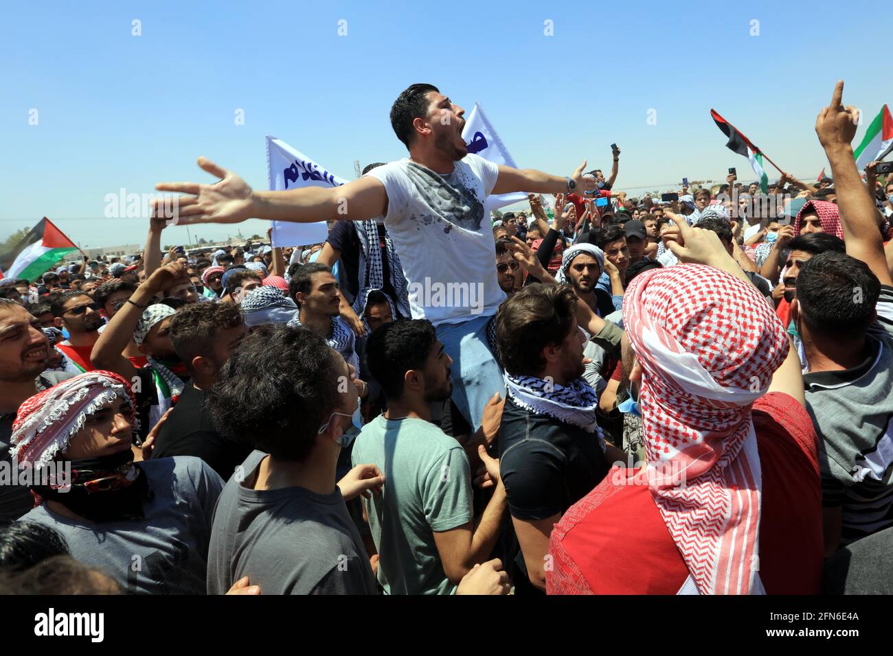 Al Karama, Jordan. 14th May, 2021. People take part in a protest near the AlKarama area in the
