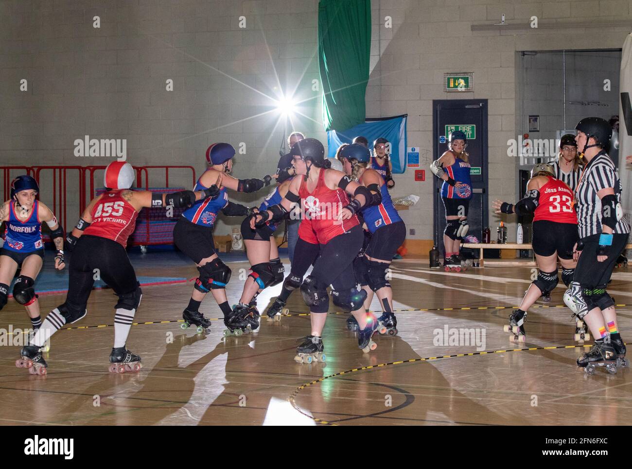 Back lit roller derby jam in progress Stock Photo Alamy