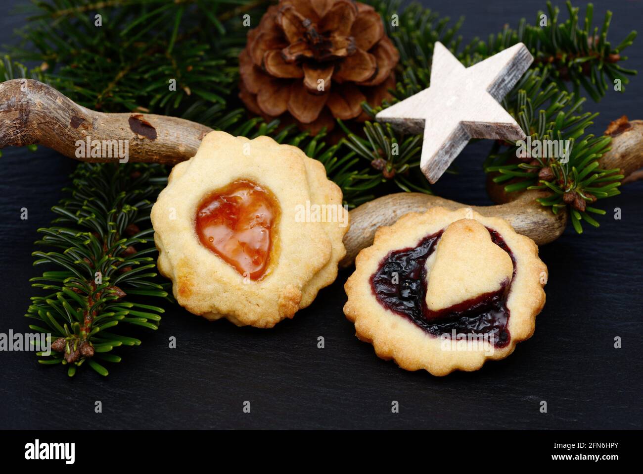 christmas cookies and fir branch lying on black shale at christmas time Stock Photo