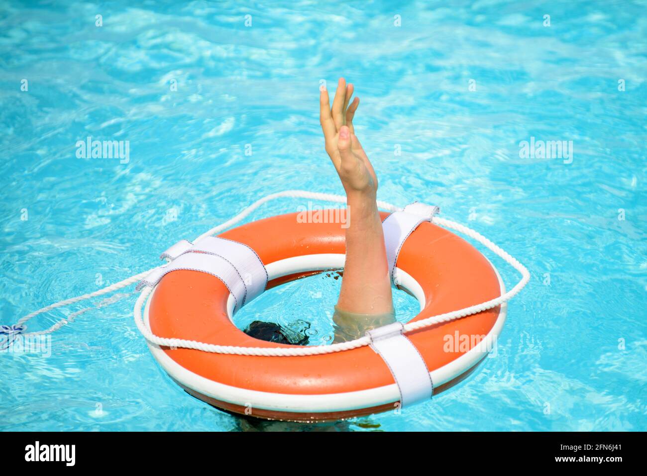 Safety equipment. Life buoy or rescue buoy floating on water. Drowning person Stock Photo Alamy