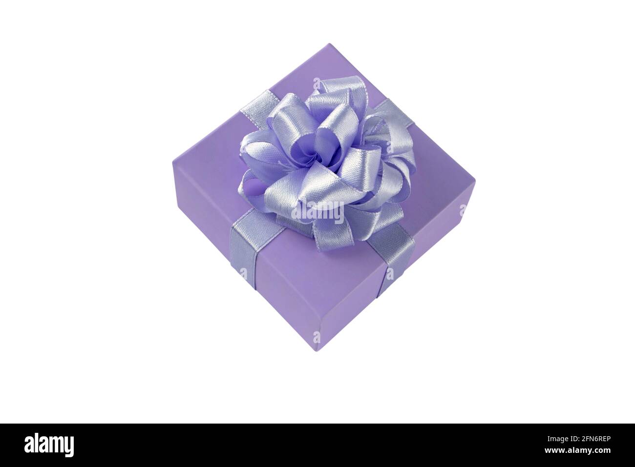 Gift box with satin ribbon bow side view isolated on white. Holidays