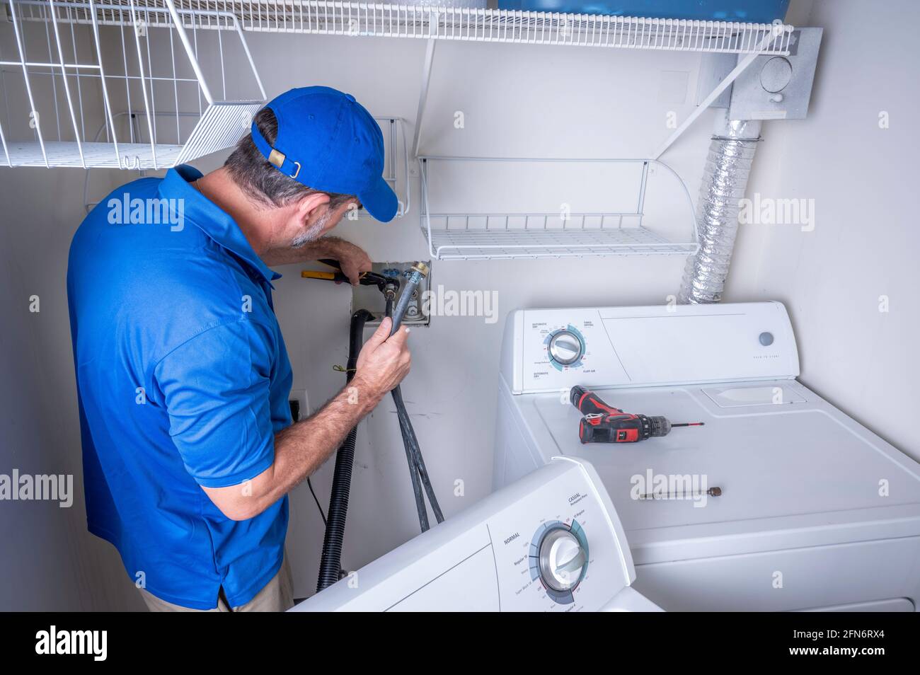 Plumber working on installing a water supply line for a residential