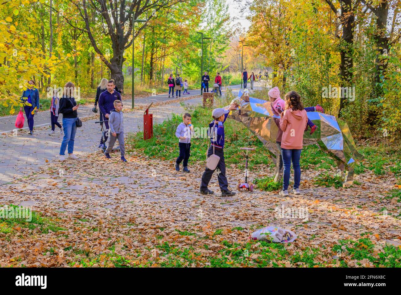 Kazan, Russia - October 03, 2020: Children with their parents are photographed next to a metal sculpture of an animal in the city's public park on an Stock Photo