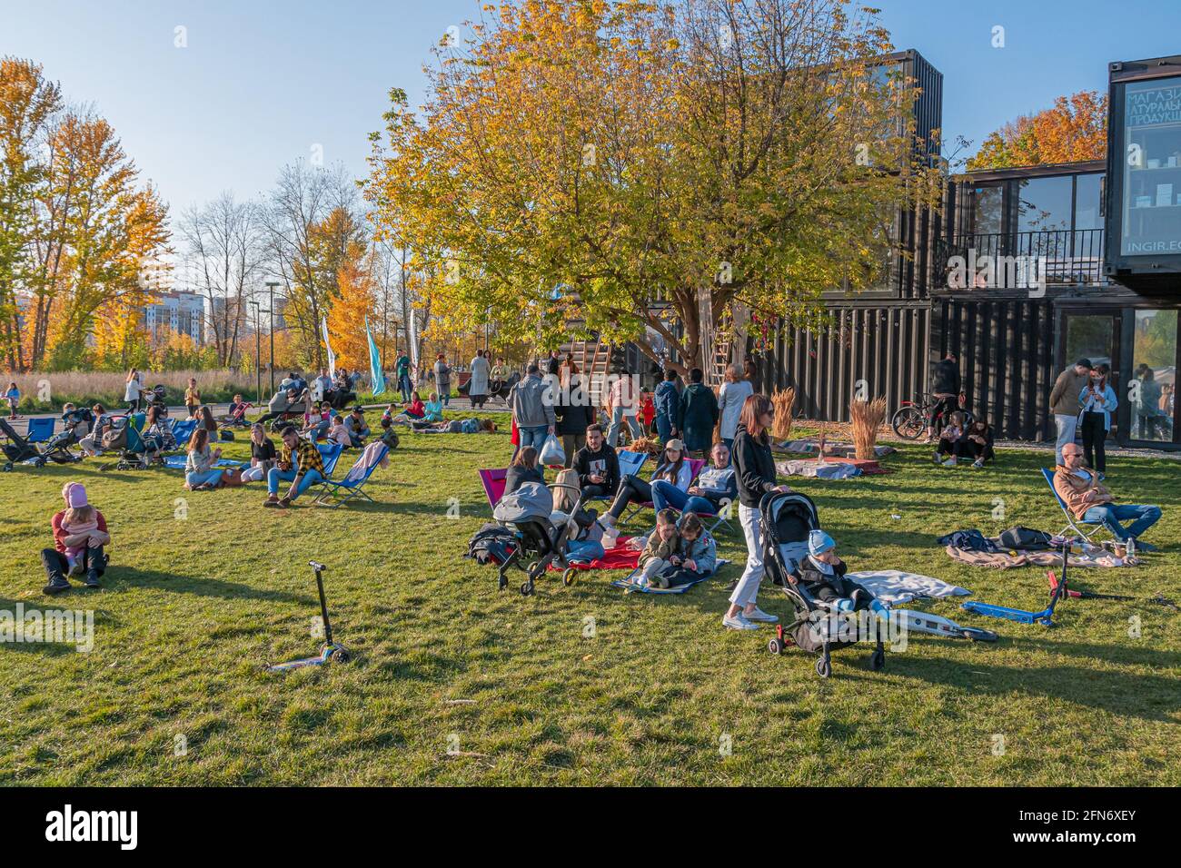 Kazan, Russia - October 03, 2020: Residents walk, relax, sit and lie on the lawn in the city park on a sunny autumn day Stock Photo