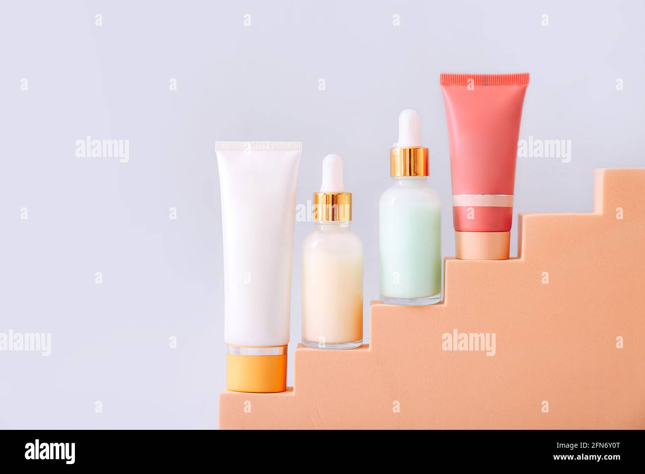Cosmetic product presentation on geometric podium on grey background. Beauty and body care product concept. Stock Photo