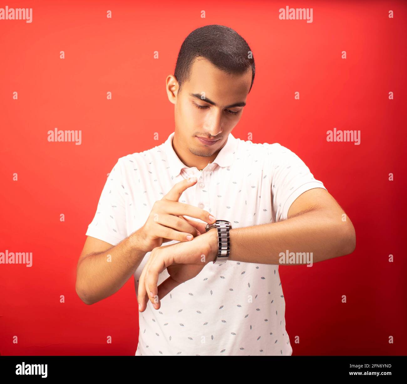 young guy looking at his time piece Stock Photo