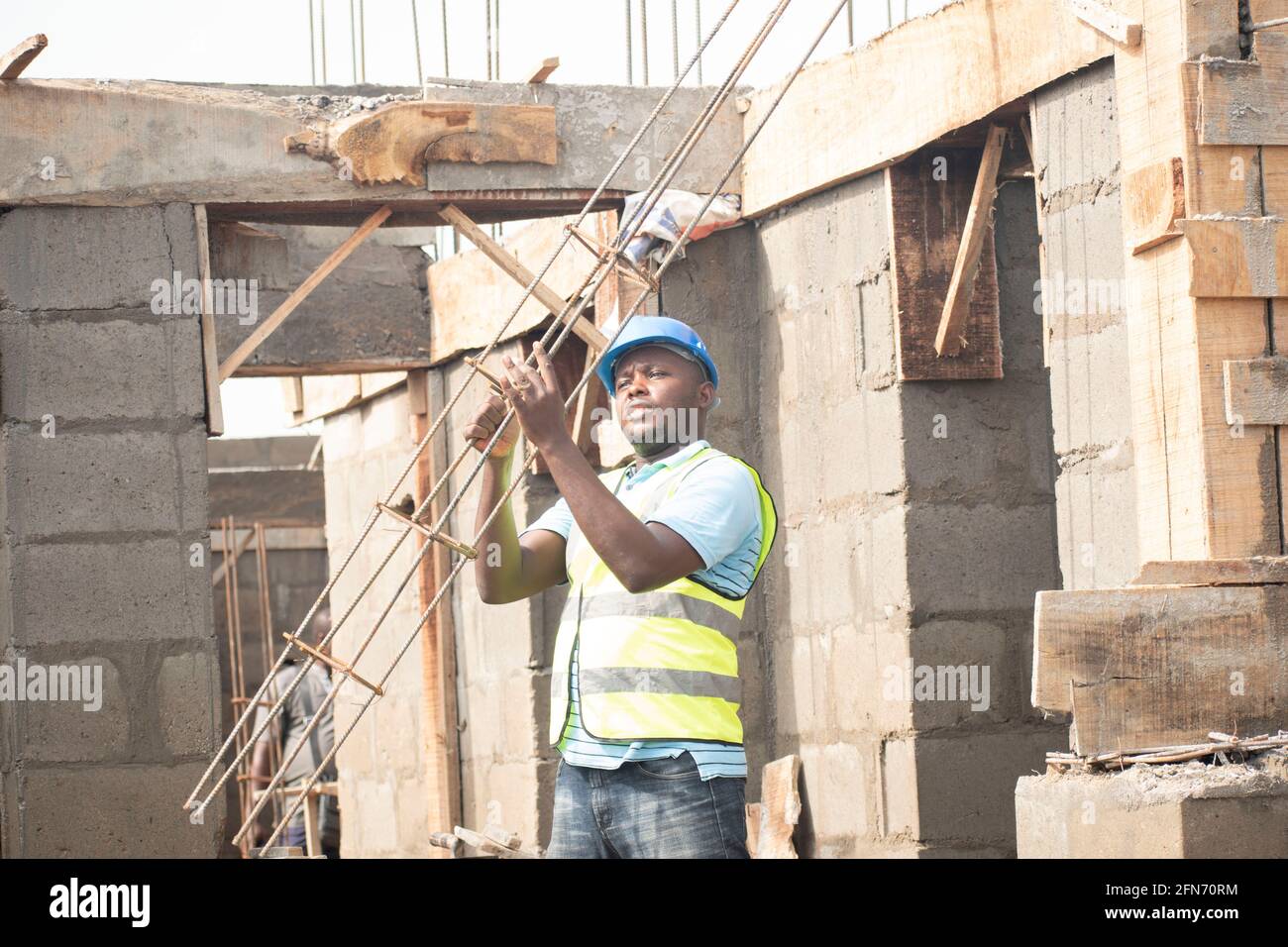 a carpenter carrying wood on site Stock Photo - Alamy