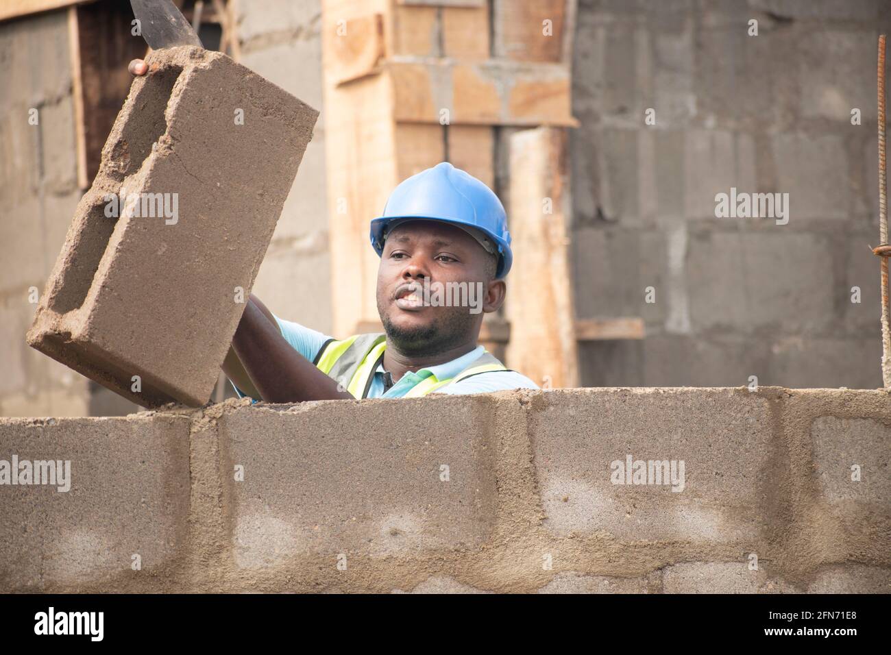a bricklayer laying bricks on site Stock Photo