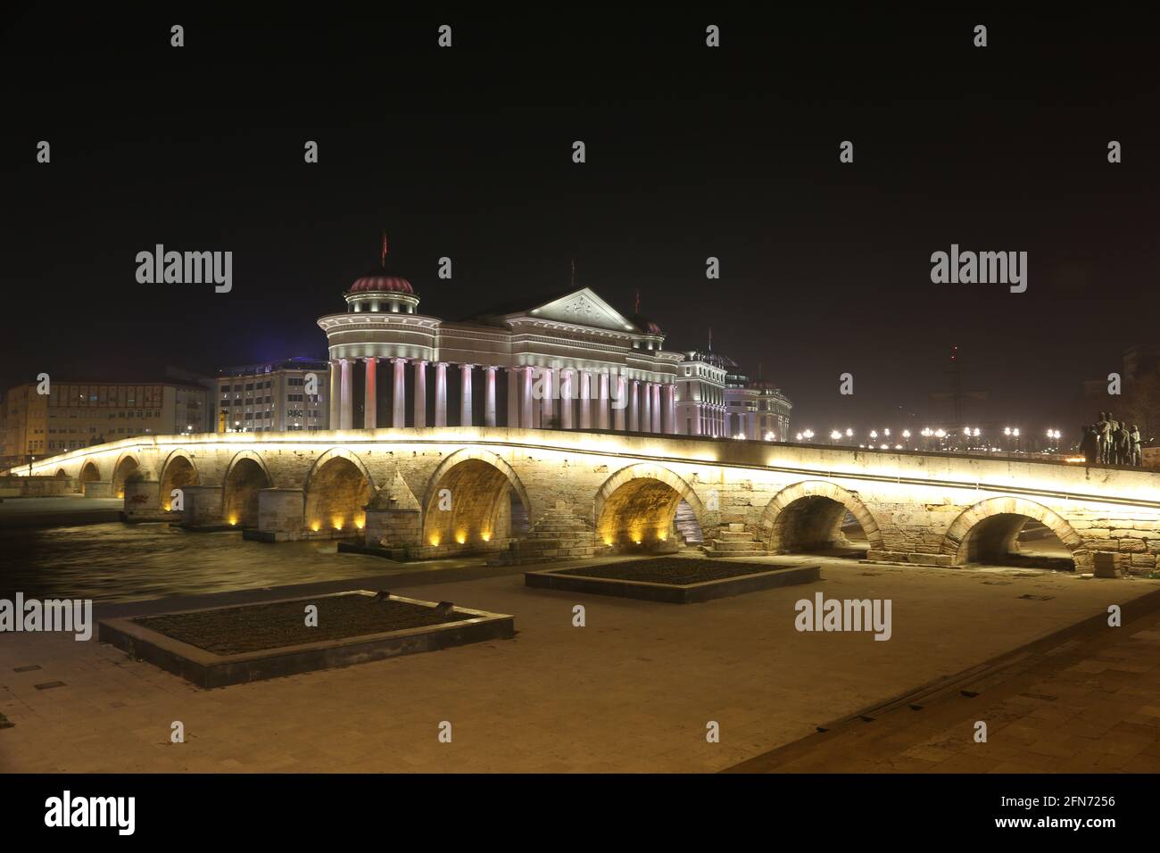 Stone Bridge, behind the Archeology Museum at night in Skopje, Macedonia. Stone Bridge is considered a symbol of Skopje. Stock Photo