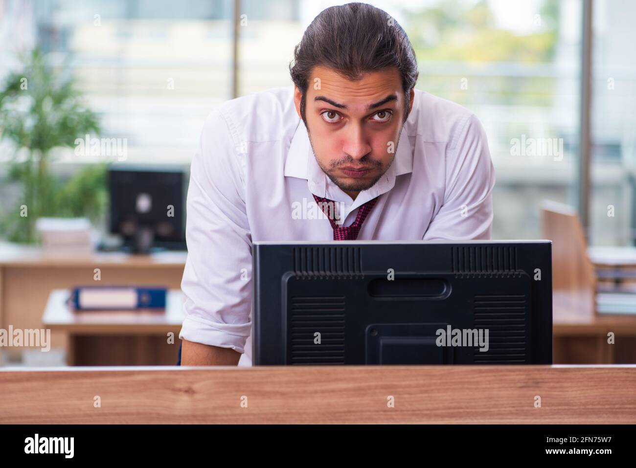 Young employee and too many work in the office Stock Photo - Alamy