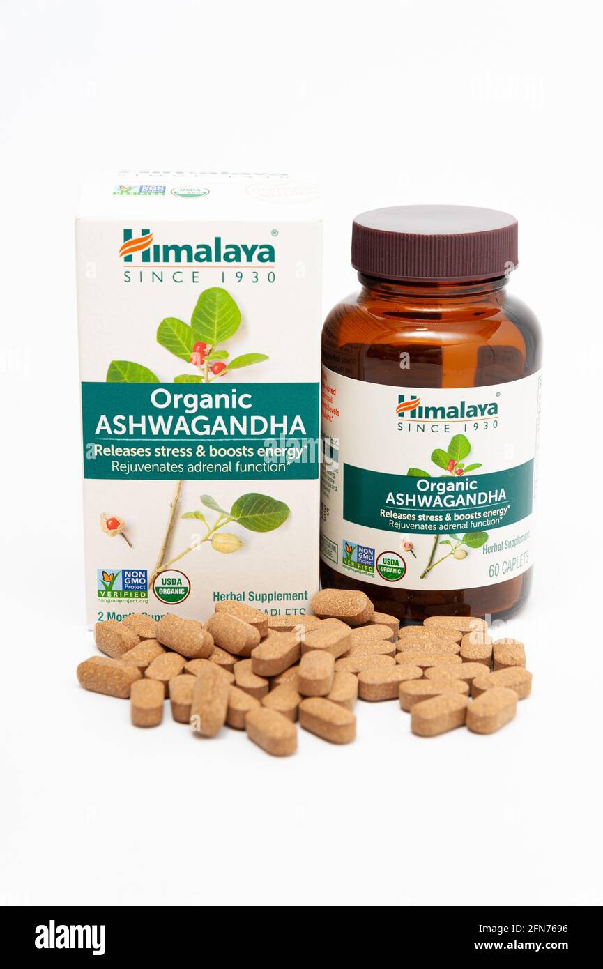Fuji City, Shizuoka-Ken, Japan - April 30, 2021: Nutritional supplement Ashwagandha by Himalaya with scattered caplets. Isolated on white background. Stock Photo
