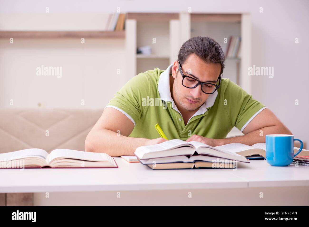 Young student preparing for exams at home Stock Photo - Alamy