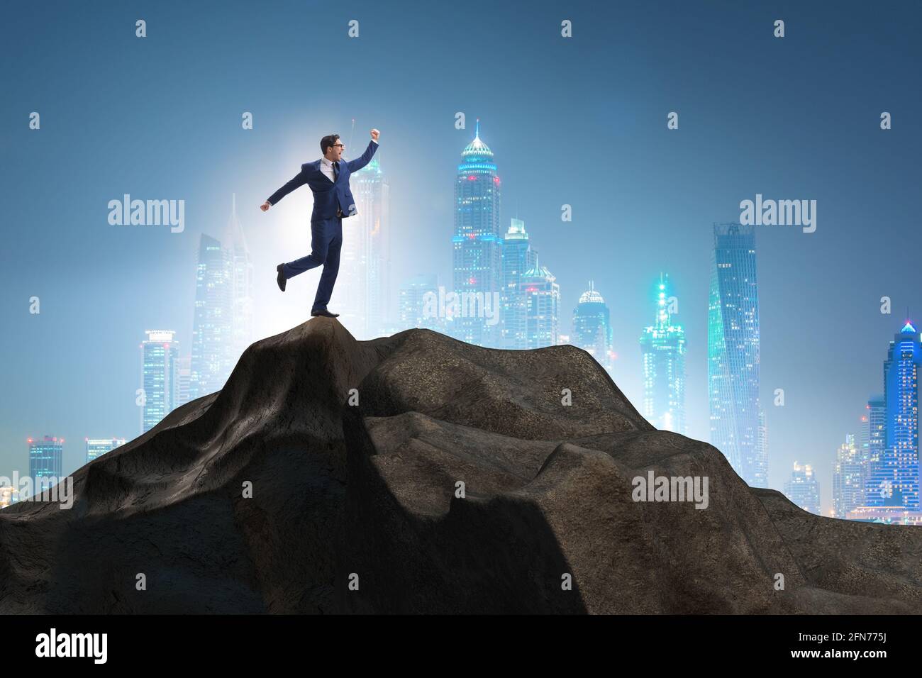 Businessman at the top of mountain in the career concept Stock Photo ...