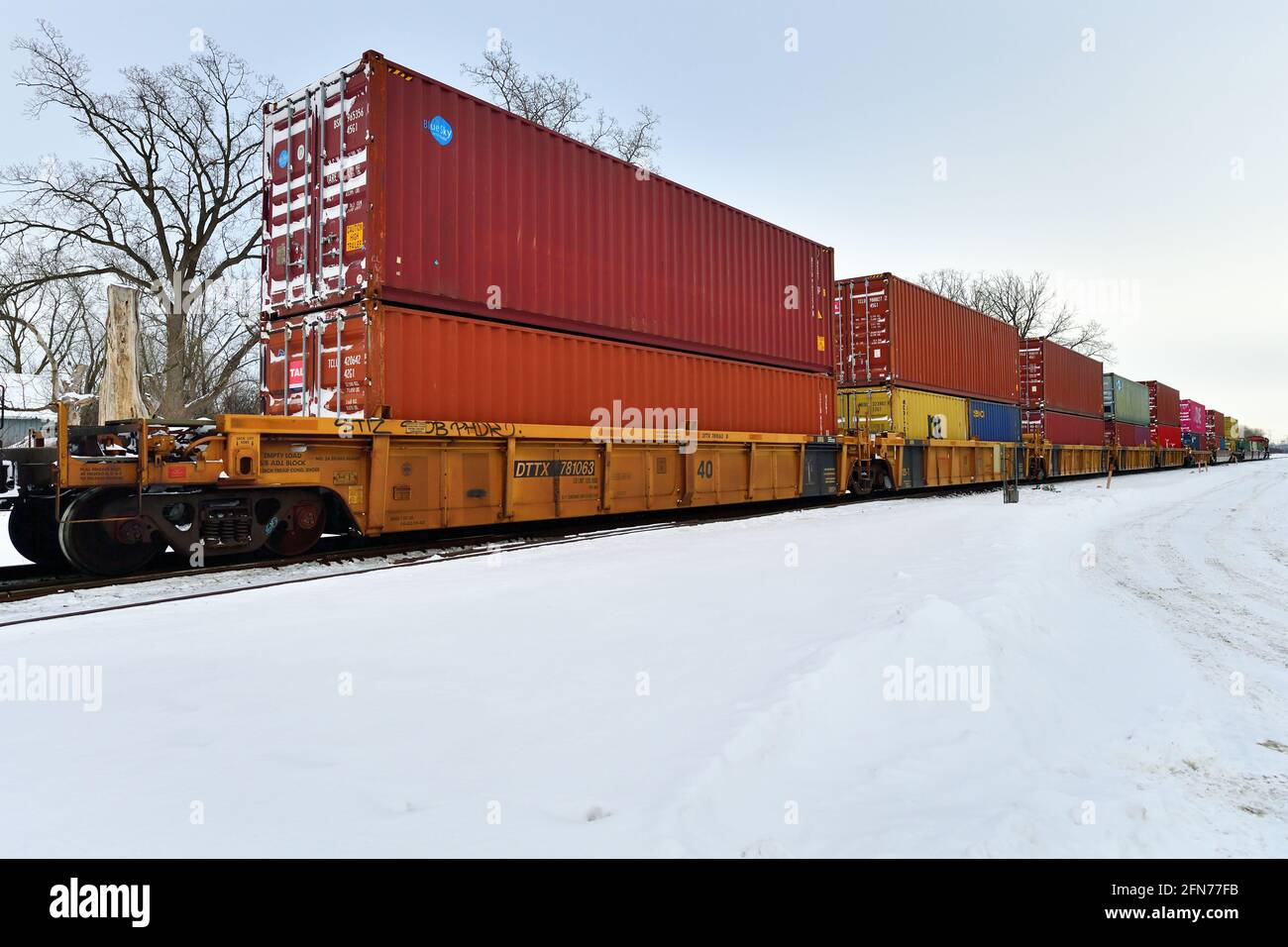 Bartlett, Illinois, USA. A Canadian National Railway intermodal freight train moving through Illinois on a winter afternoon. Stock Photo