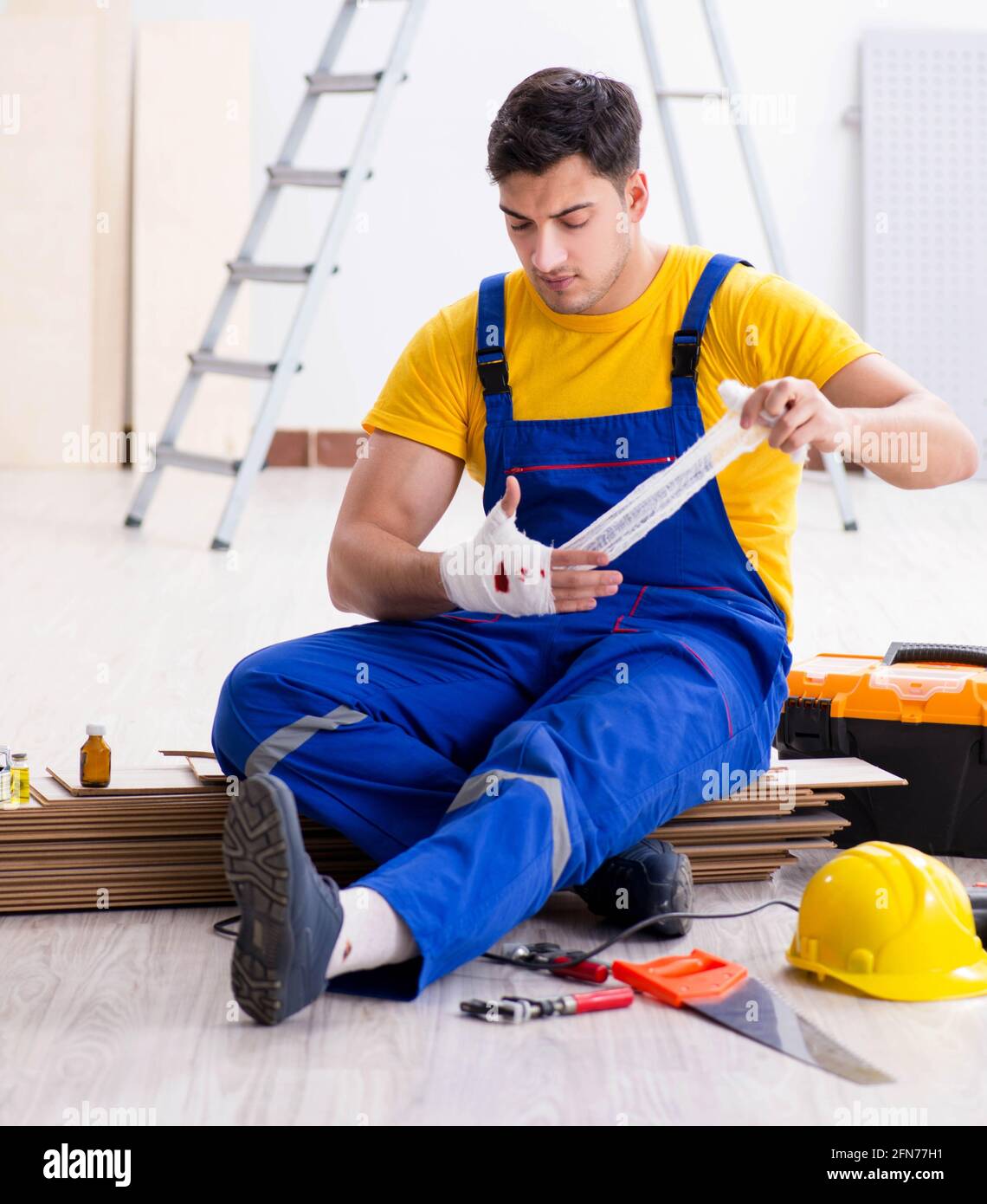 The worker with injured hand at construction site Stock Photo - Alamy