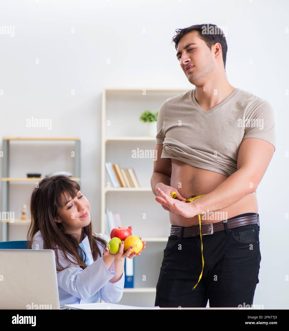 The doctor dietician giving advices to fat overweight patient Stock