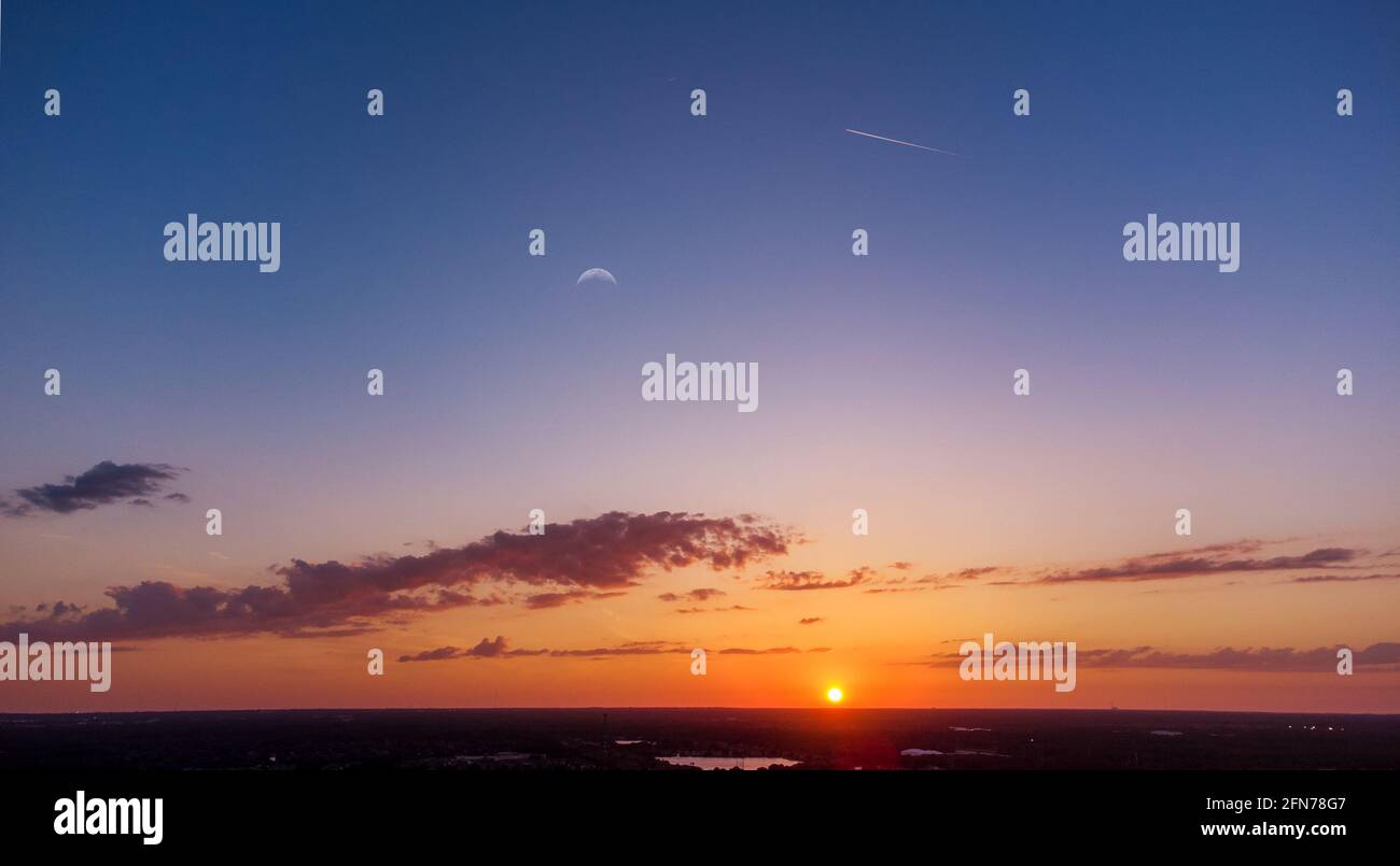 Interesting aerial landscape with a plane with contrails flying and the ...