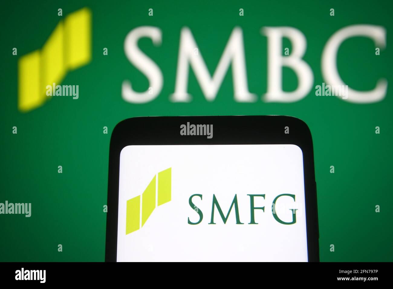 Ukraine. 15th May, 2021. In this photo illustration the Sumitomo Mitsui Financial Group (SMFG) logo is seen on a smartphone screen in front of Sumitomo Mitsui Banking Corporation Group (SMBC) logo of a Japanese multinational banking and financial services in the background. (Photo by Pavlo Gonchar/SOPA Images/Sipa USA) Credit: Sipa USA/Alamy Live News Stock Photo