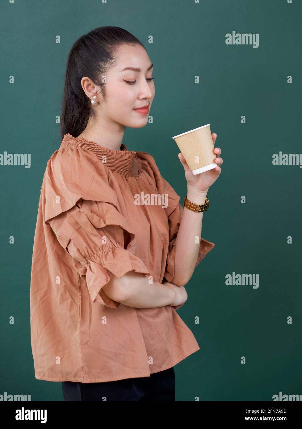 Young asian woman in casual dress with a smile holding coffee drink in ...