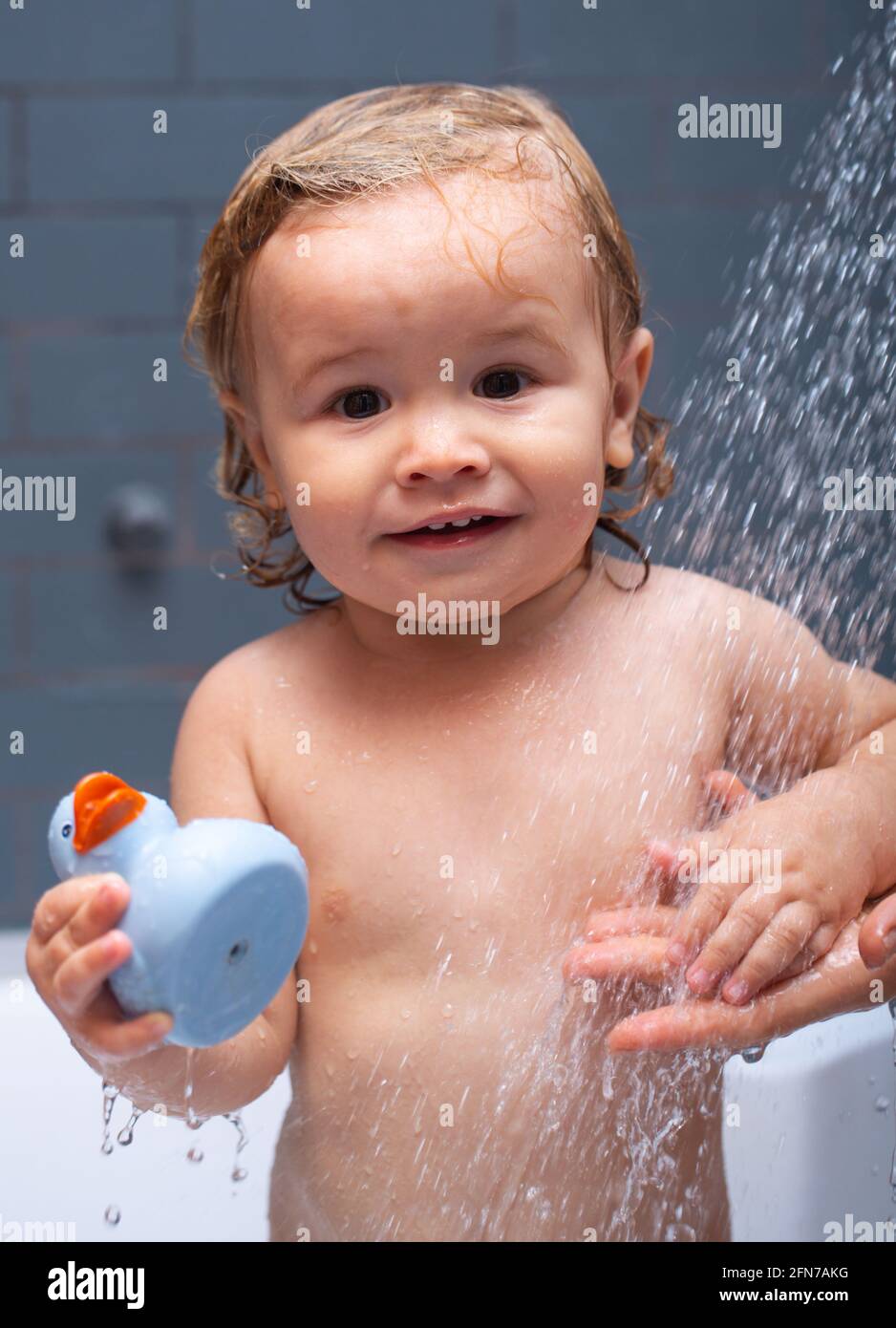 Bathing baby. Happy kid with soap foam on head. Kid shower Stock Photo