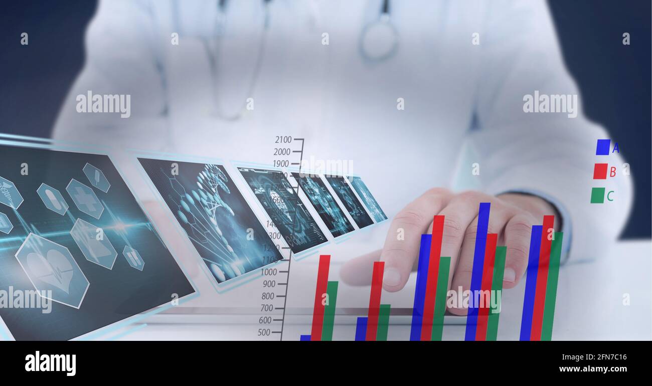 Statistical and medical data processing against mid section of doctor using digital tablet Stock Photo