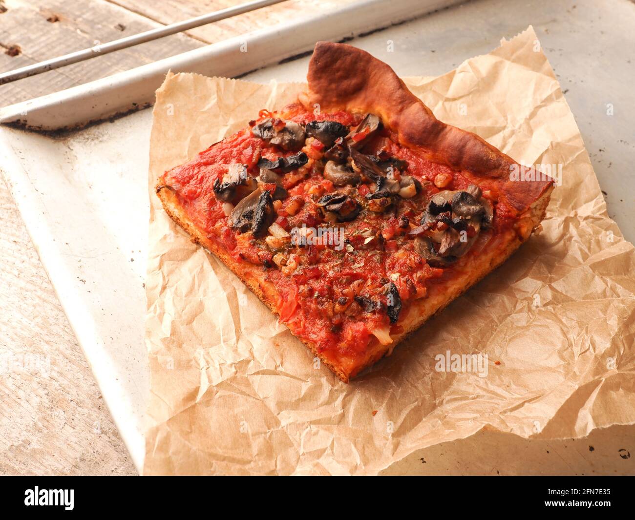 Vegetarian pizza with mushrooms, tomatoes and garlic without cheese. For people with lactose intolerance. Healthy organic food Stock Photo
