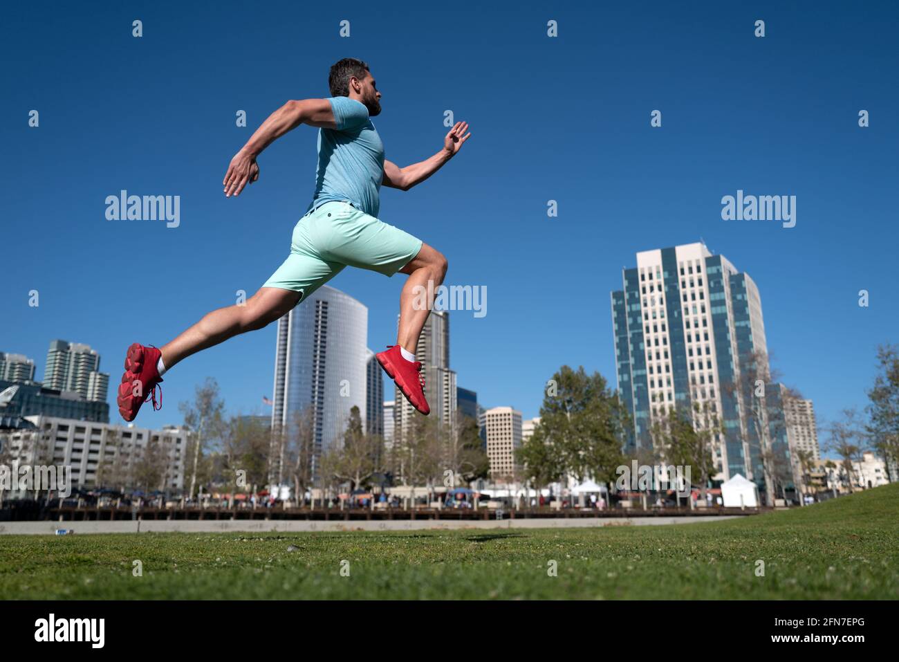 Athletic young man running in city. Dynamic jumping movement. Young and