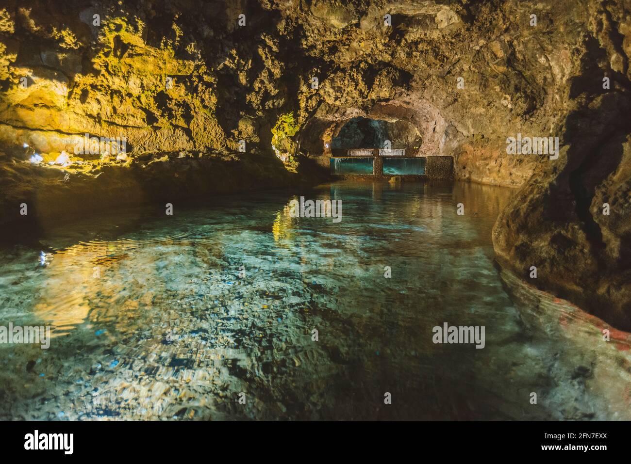artificial light reflections in underground lake inside volcanic cave from Madeira Island Stock Photo