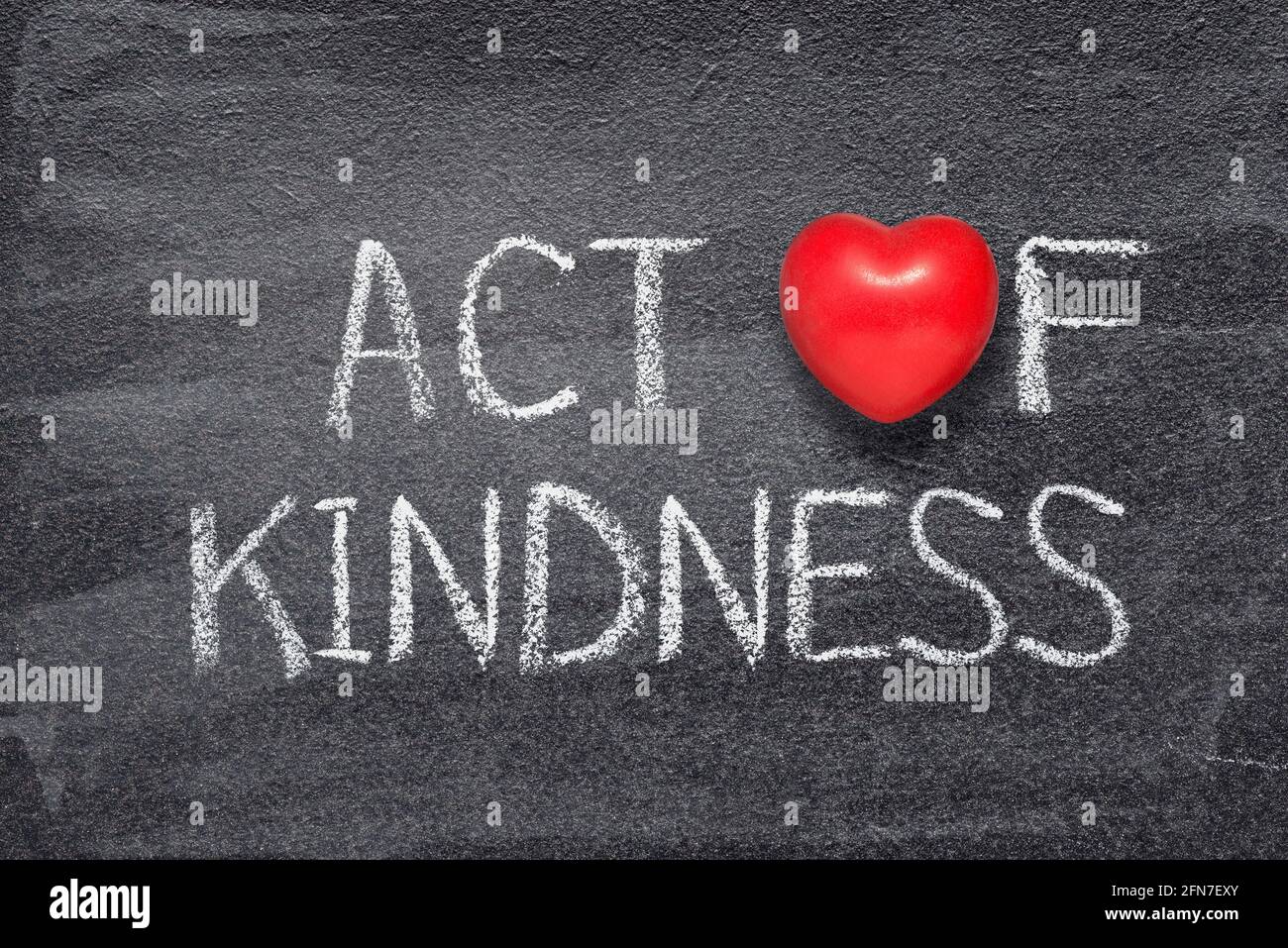 act of kindness phrase written on chalkboard with red heart symbol ...