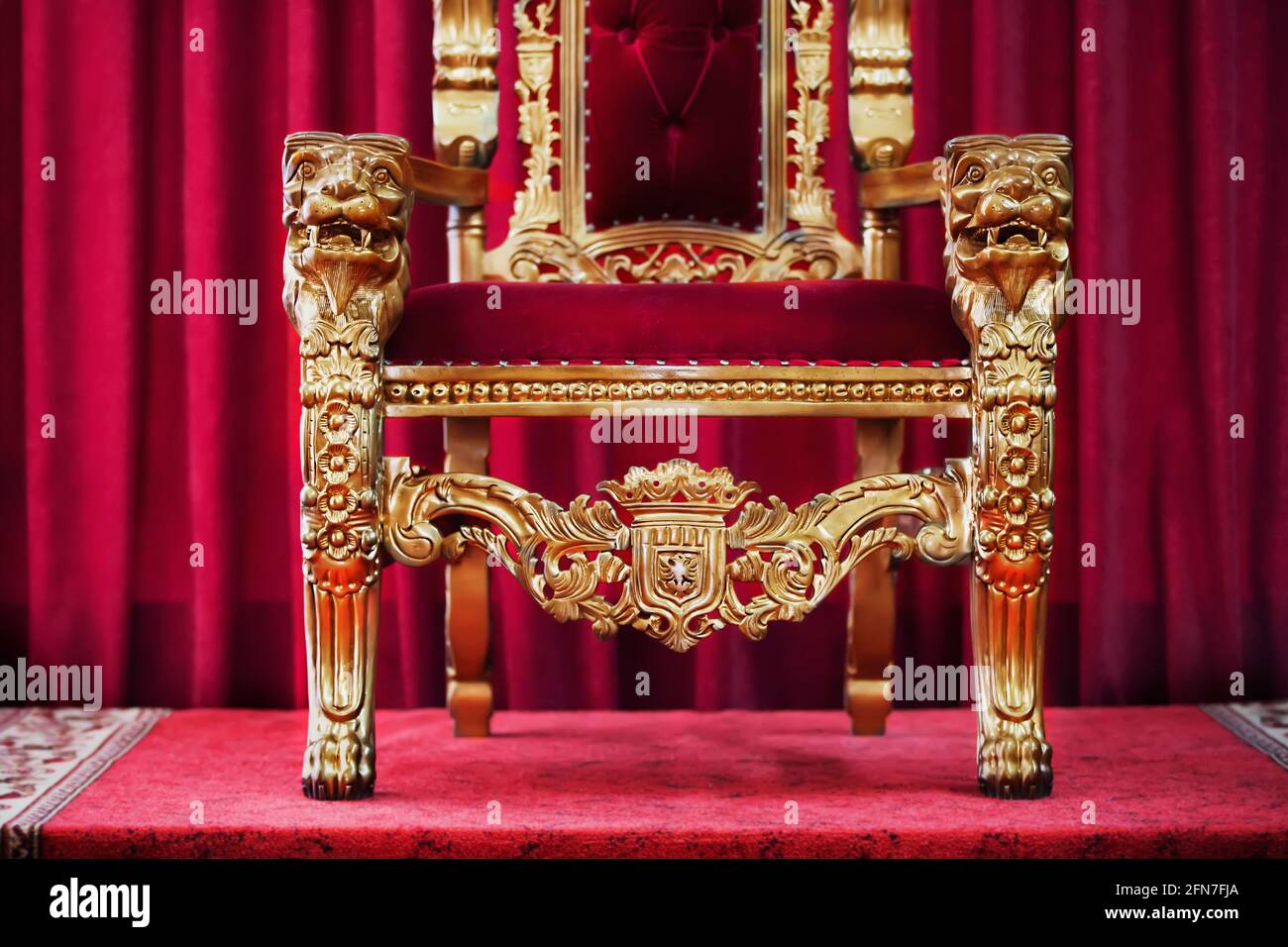 Part of the red royal chair against the background of red curtains. A place  for a king. Throne Stock Photo - Alamy