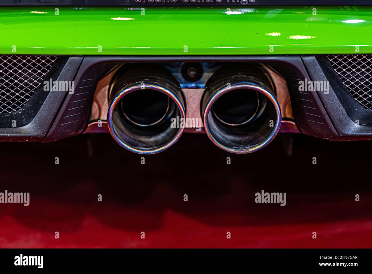 closeup of modern luxury car dual exhaust pipes, vehicle smog