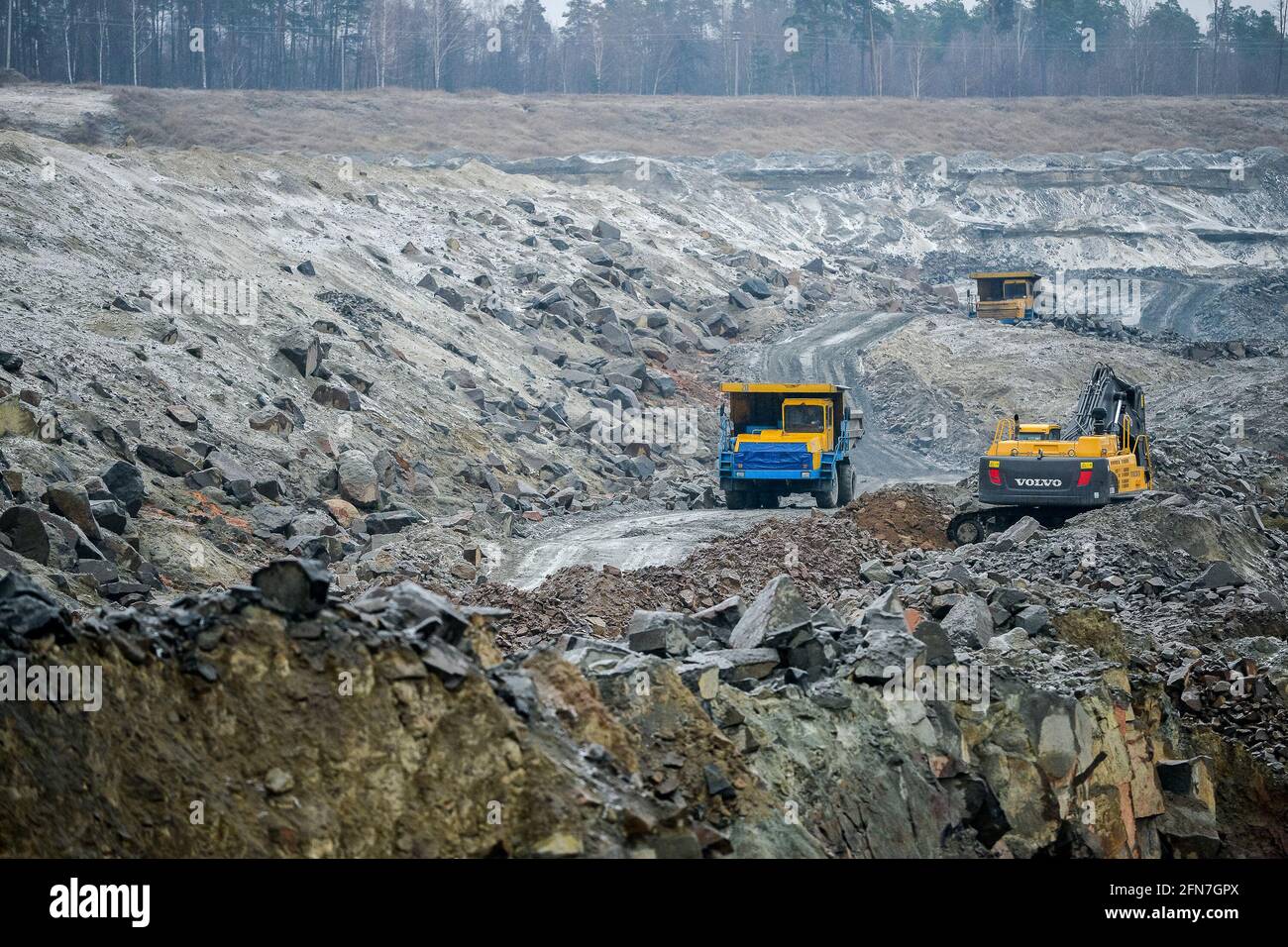 Production Mining of granite stone by the quarrying machines in Mikashevichi.  Stock Photo