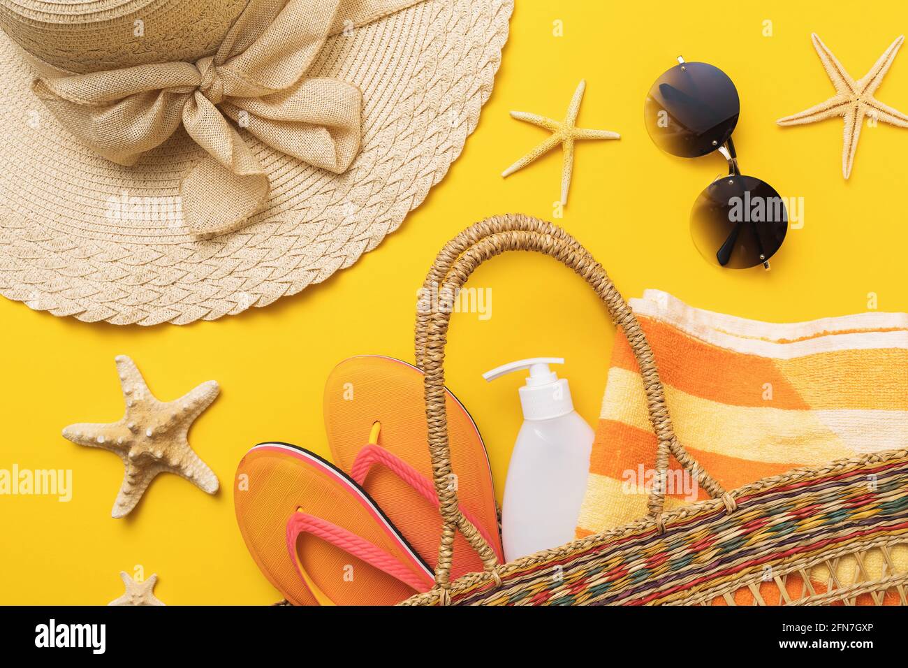 Flat composition with beach holiday accessories on colored background with top view, summer background. Stock Photo