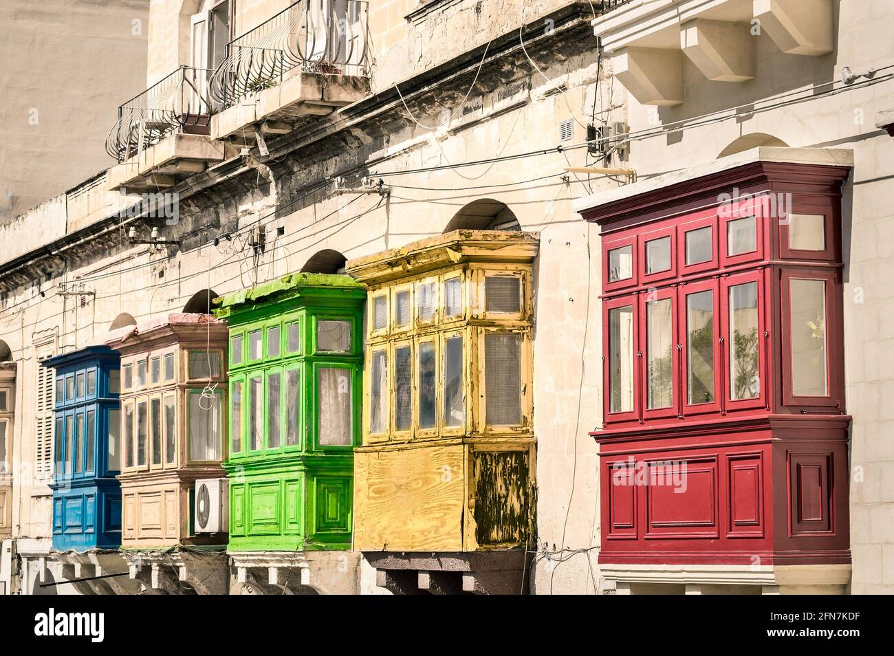 Vintage view of typical buildings balconies in La Valletta  - Colorful travel in Malta on the road - Popped up filtered version Stock Photo