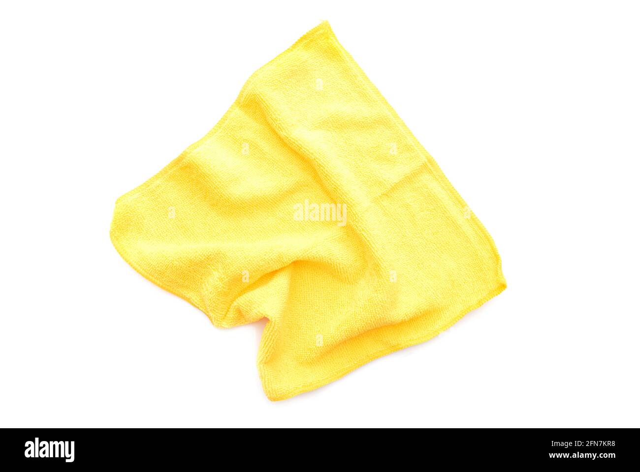 Yellow kitchen rug isolated on white. Crumpled used microfiber cloth clean, top view. Stock Photo