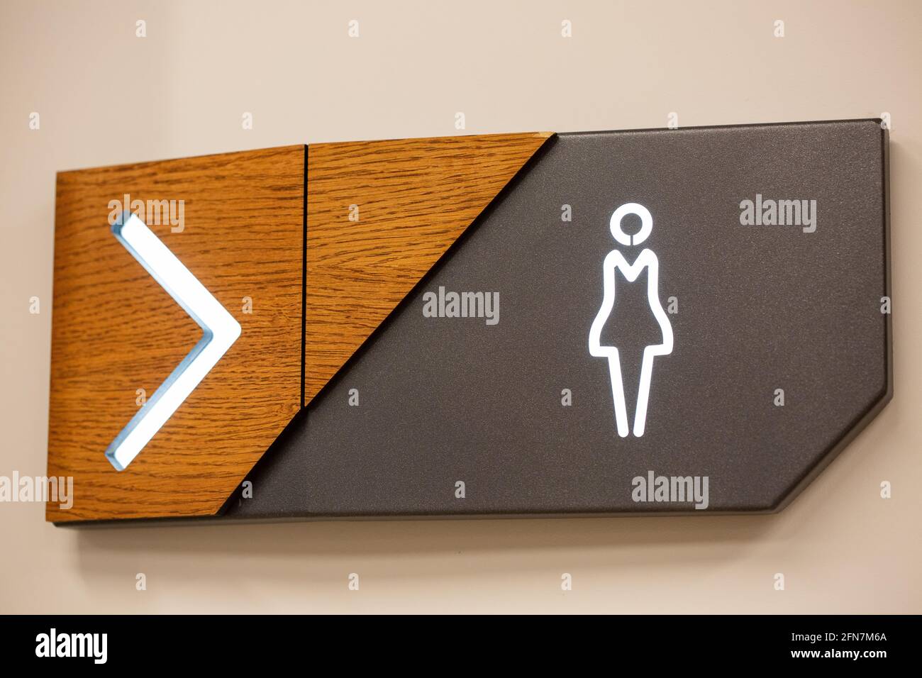 Closeup of female comfort room signage with an arrow sign showing the direction Stock Photo Alamy