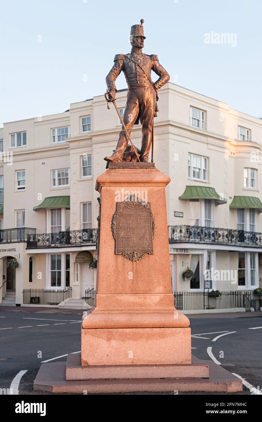 EASTBOURNE, EAST SUSSEX, UK - APRIL 30, 2012:  War memorial with bronze statue of a soldier of the Royal Sussex Regiment on Grand Parade Stock Photo